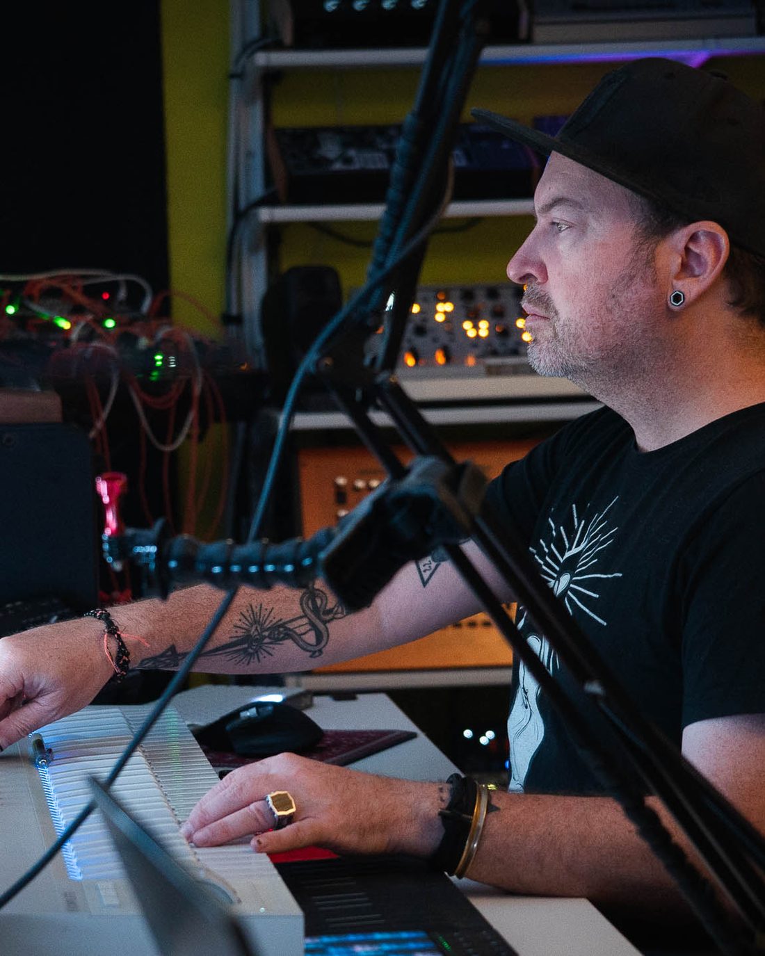 Mac Vaughn at the desk, hands on the keys