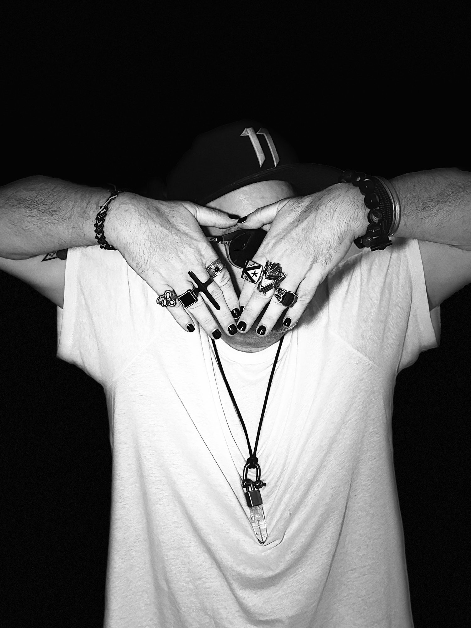 Mac Vaughn, hands folded into a triangle over his face